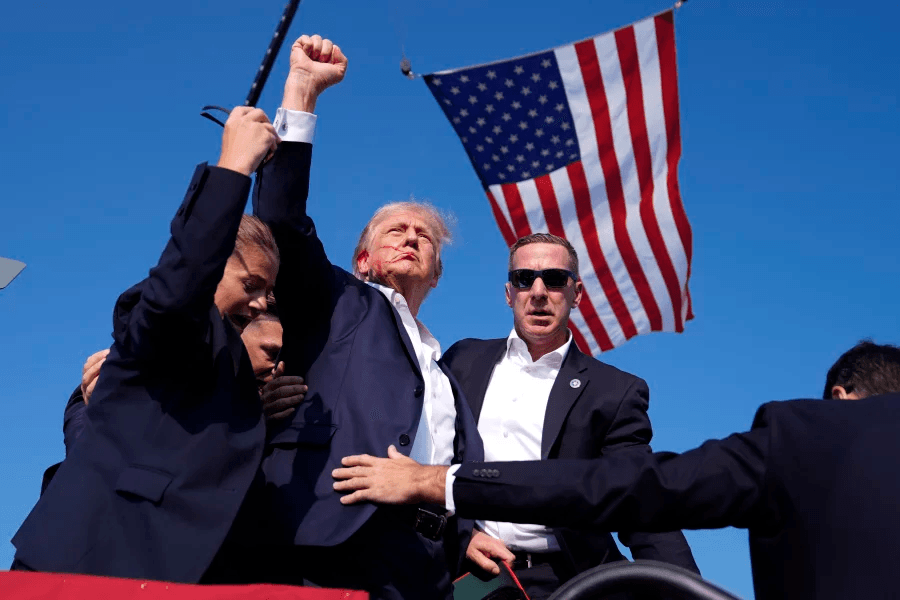 Former President Donald Trump is rushed offstage during a rally in Butler, Pa.